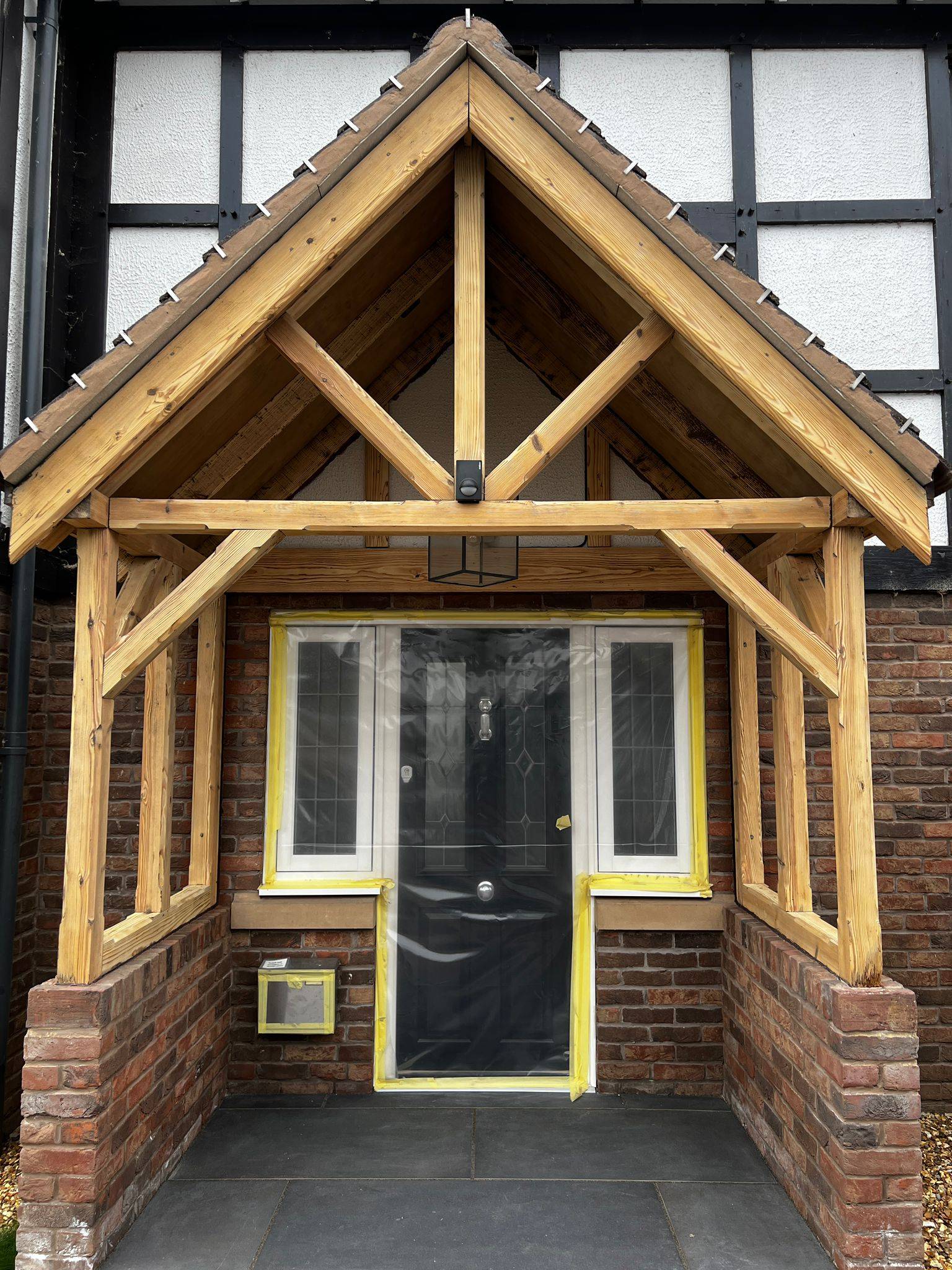 Oak porch frame after restoration showing bright natural grain and enhanced kerb appeal