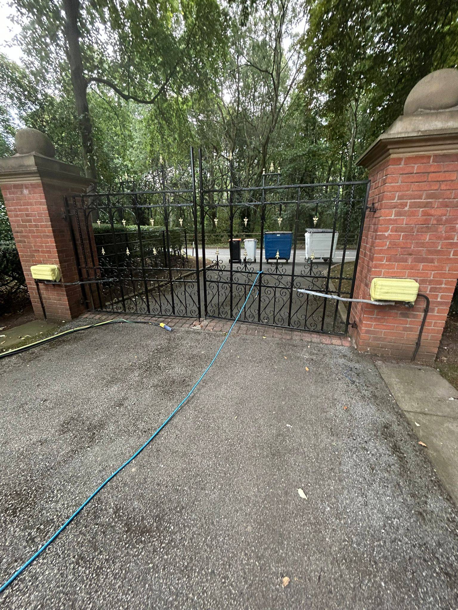Metal gate before restoration with flaking paint, surface rust and weathered appearance