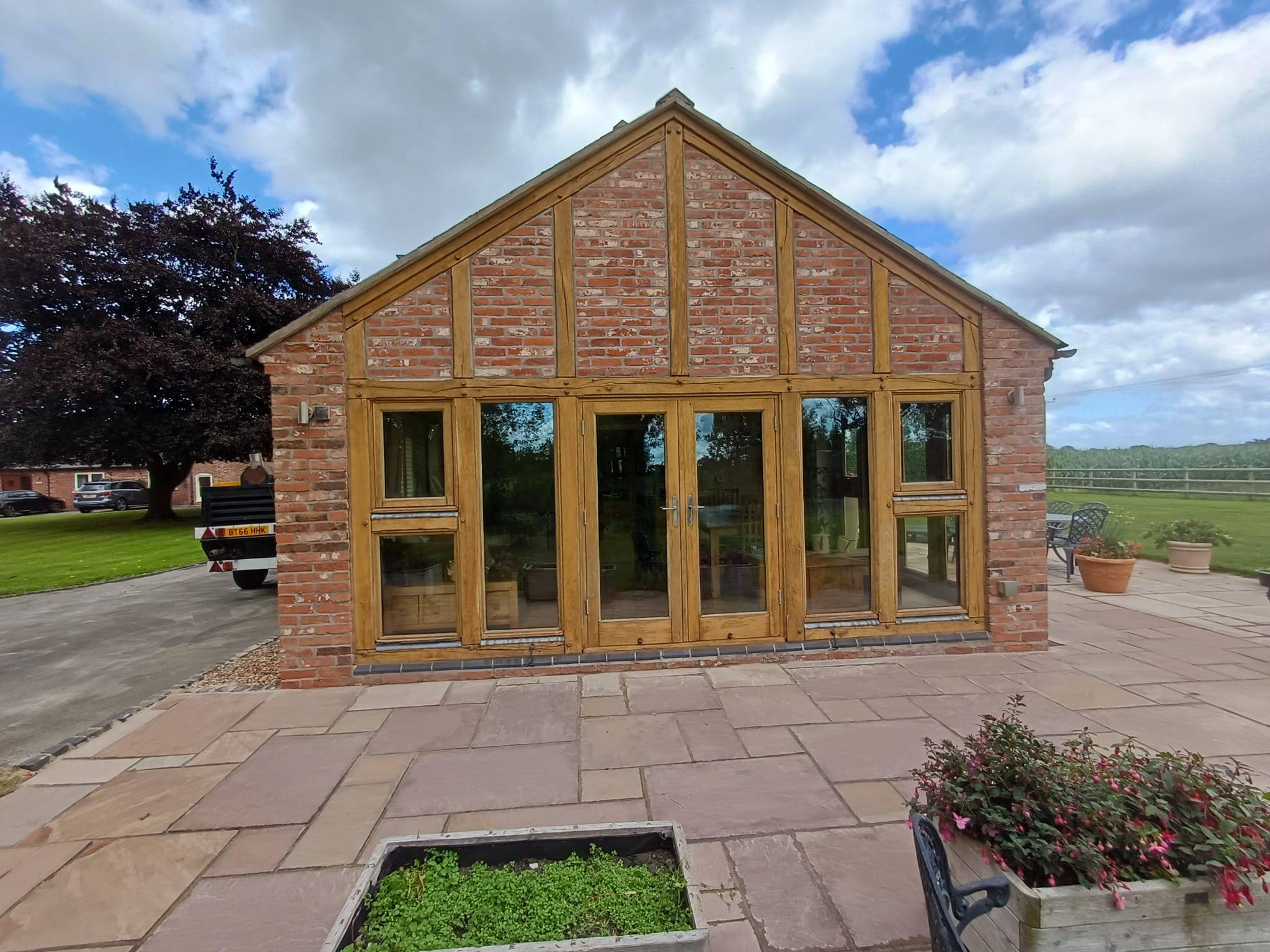 Timber outbuilding after soda blasting with fresh natural timber colour and glass protected