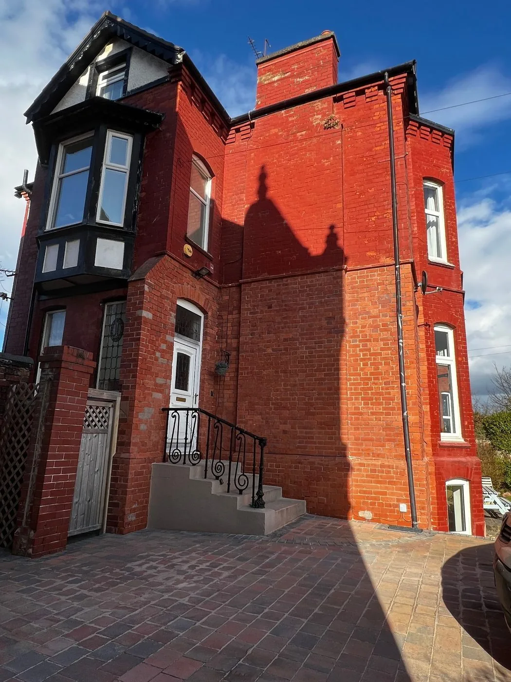 Restored Victorian red brick corner with natural colour and masonry texture visible after paint removal