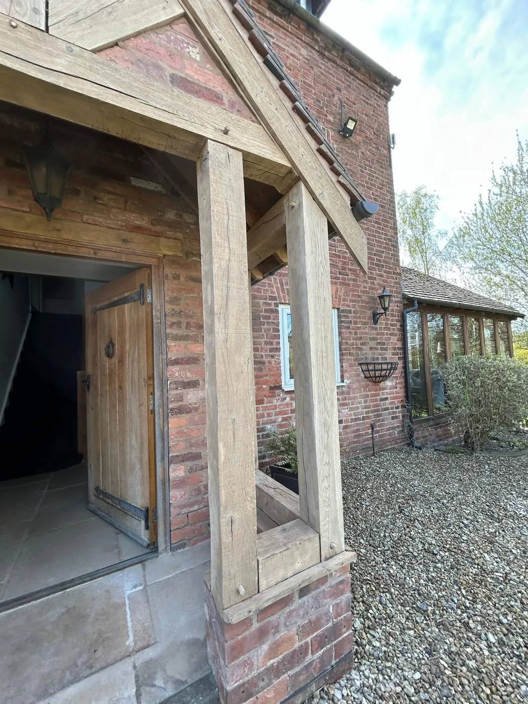 Restored oak porch frame with a clean golden timber surface and clearer grain