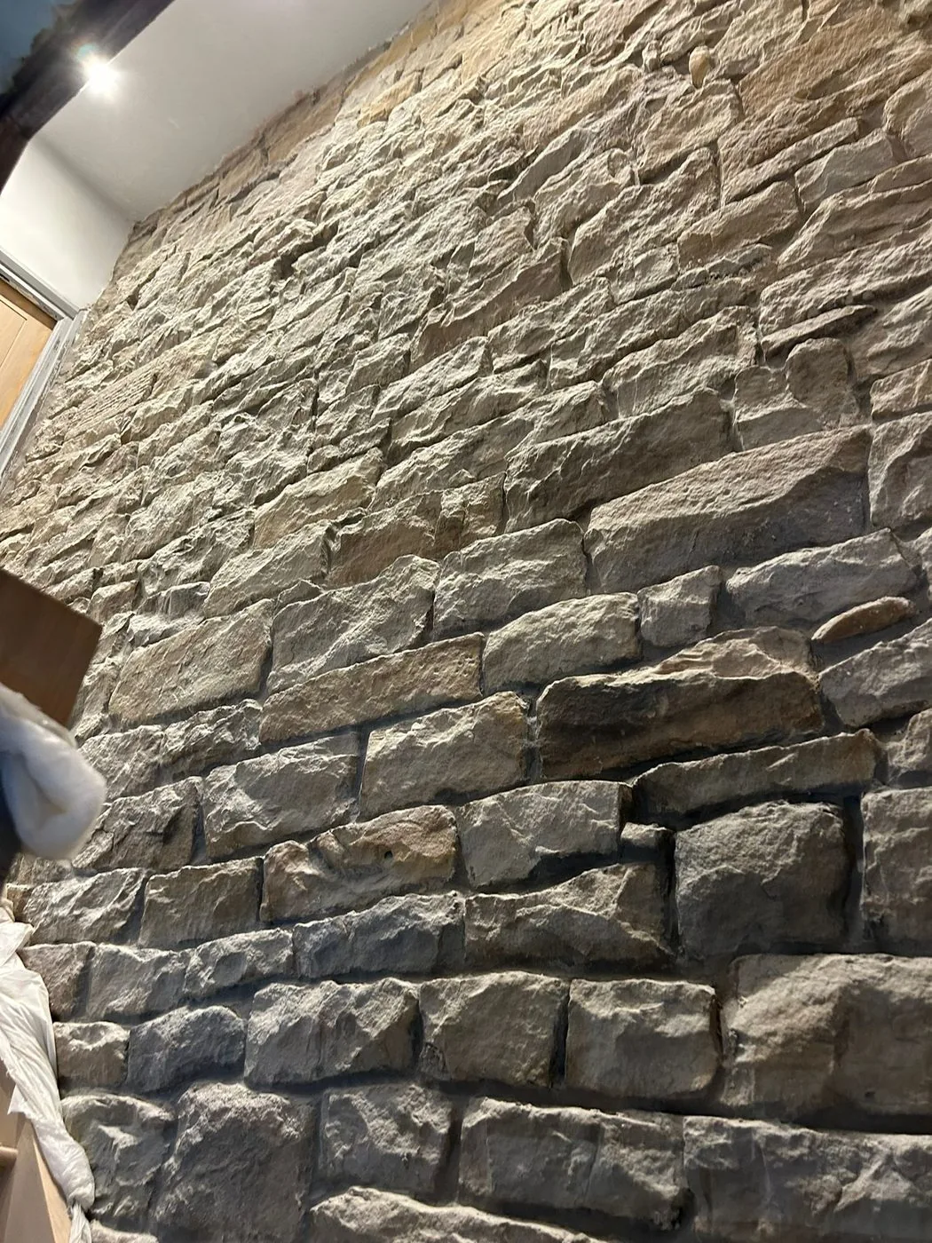 Freshly cleaned sandstone wall showing clearer natural colour and texture