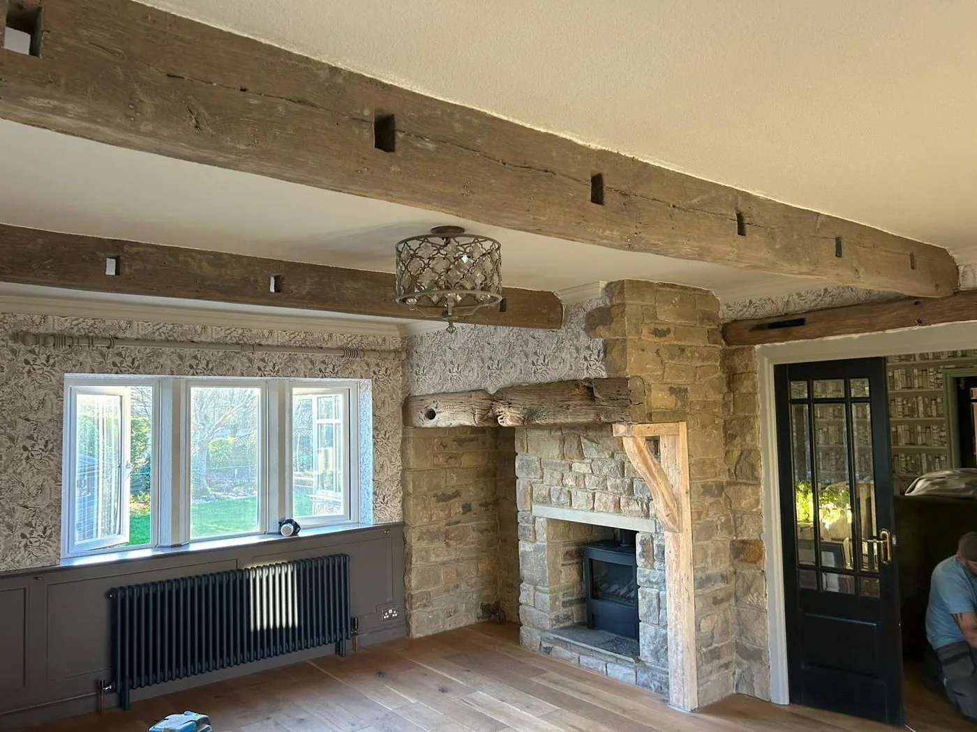 Restored oak beam after gentle paint removal, showing a clean natural surface and visible wood grain.