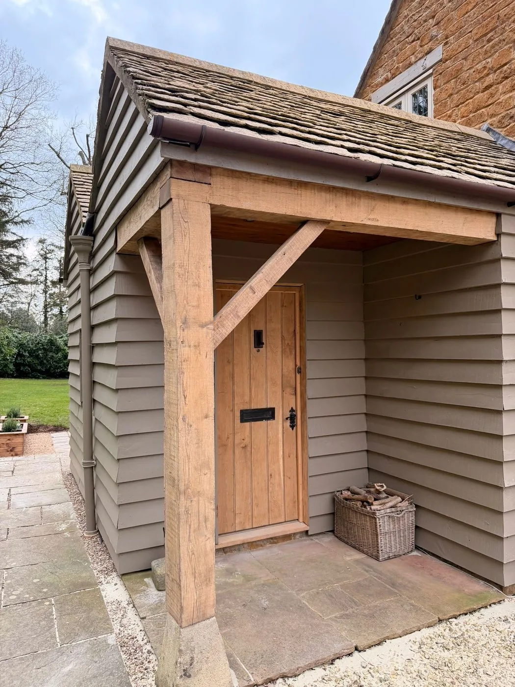 Renewed oak porch door showing an even clean surface after restoration