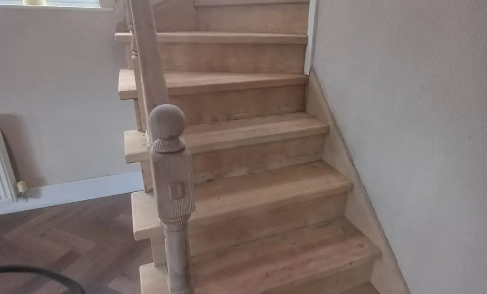 Restored staircase details showing a bright finish-ready timber surface