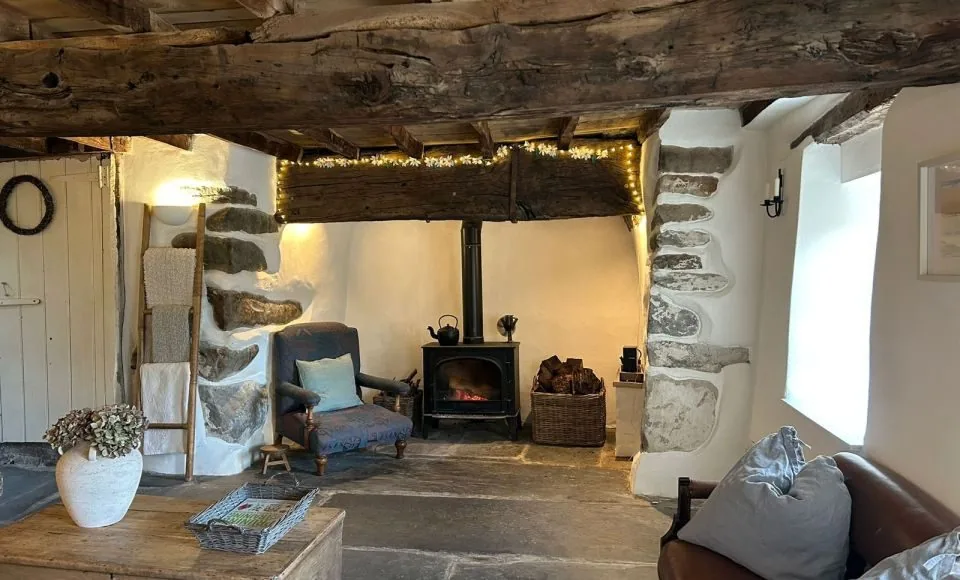 Restored historic timber beams showing a cleaner natural finish after black paint removal