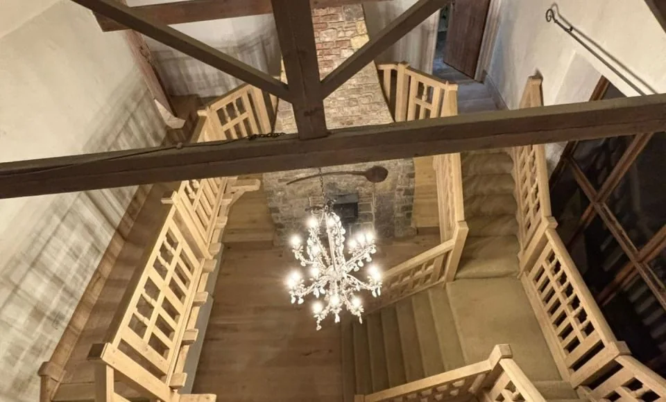 Additional restored view of a grand oak staircase and landing