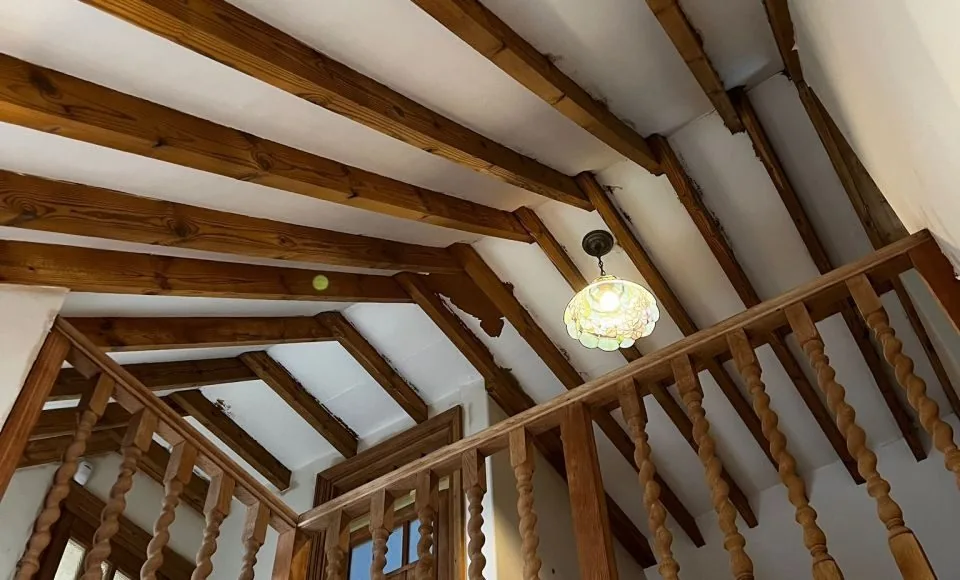 Landing timber and ceiling beams after careful cleaning with grain clearly visible