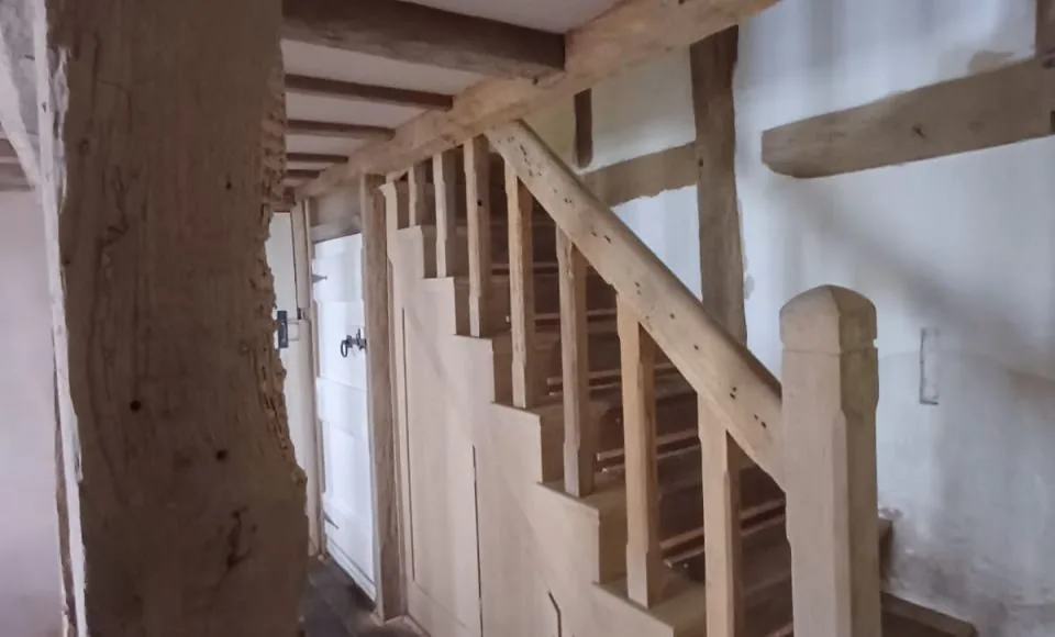 Brightened staircase with clean, clearly defined restored timber