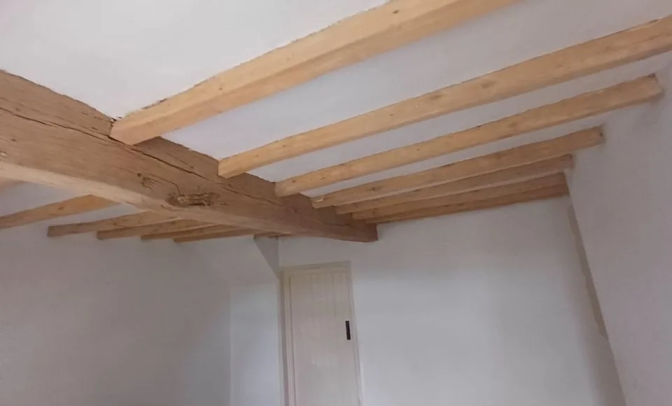 Brightened restored oak beam with natural character visible