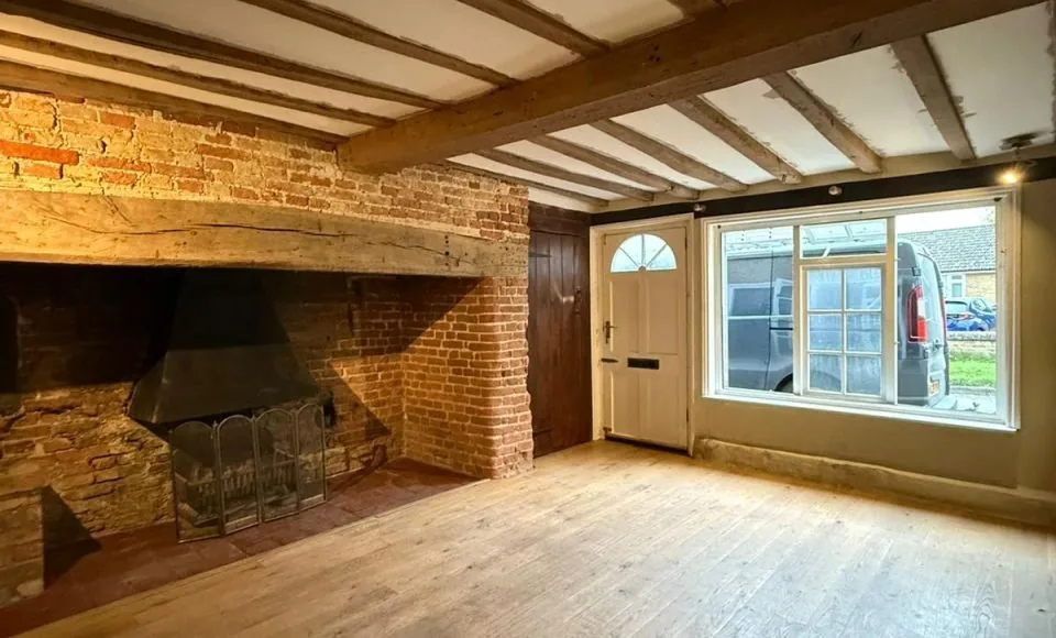Cleaned fireplace beams with a lighter natural timber appearance after restoration
