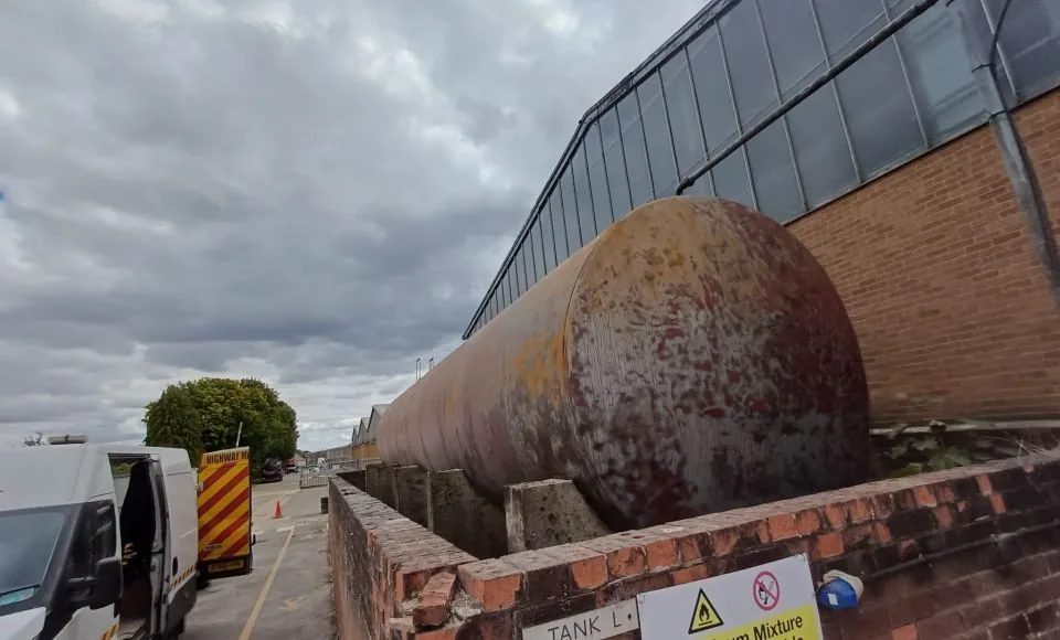Restored tank surface showing consistent bare steel and removal of corrosion and loose paint