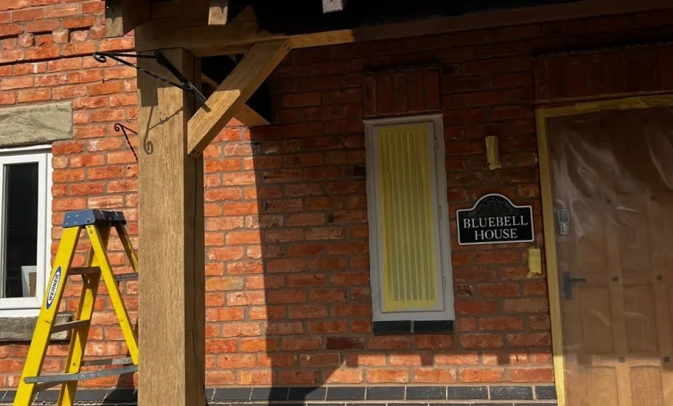 Lightened exterior porch timber showing clearer natural grain after restoration