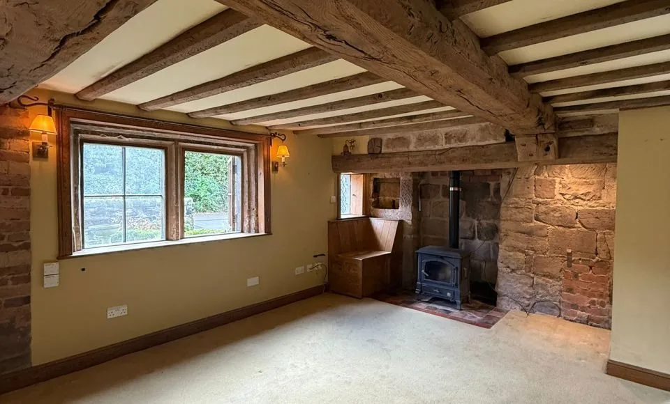 Restored fireplace with warmer timber tones and clearer architectural detail
