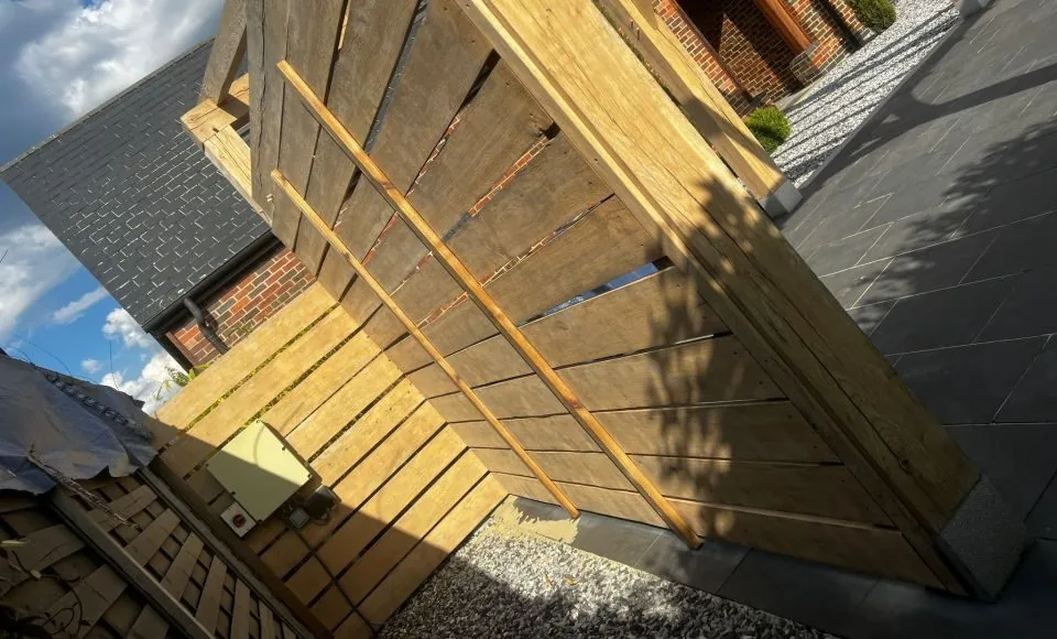 Restored pergola framework showing even clean timber across posts and roof rails
