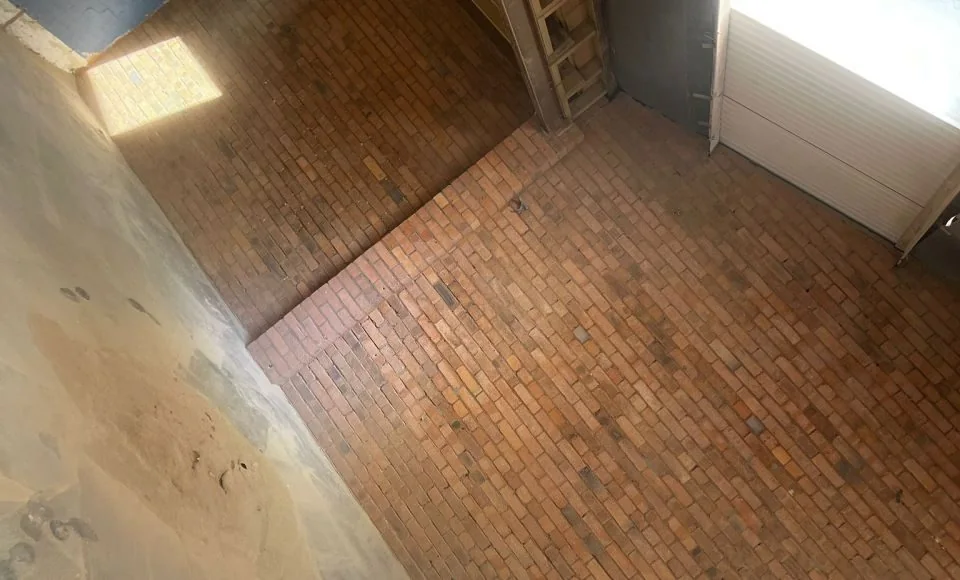 Interior brick wall after paint removal with original brickwork exposed