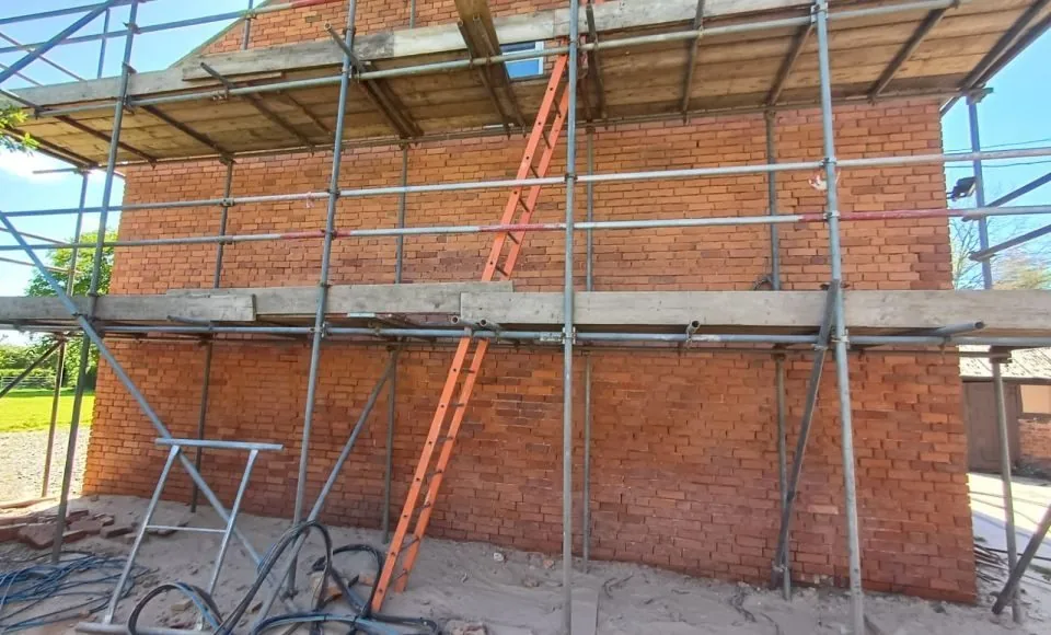 Side elevation after careful cleaning, showing clearer brick faces and a more even restored appearance.