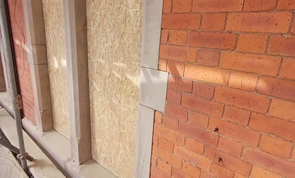 Refreshed exterior masonry showing cleaner brickwork and restored stone character