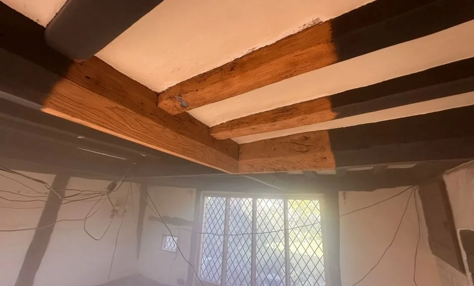 Restored oak beams with a lighter clean surface after coating removal