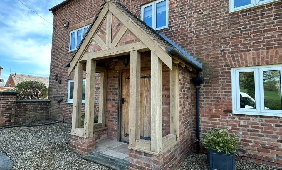 Brightened timber porch frame restored against clean red brick exterior