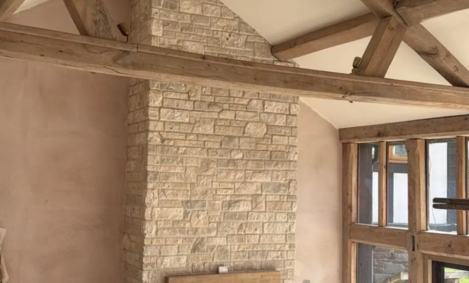 Restored living area A-frame and window timber after controlled cleaning, with a brighter, clearer surface and sharper joinery detail.