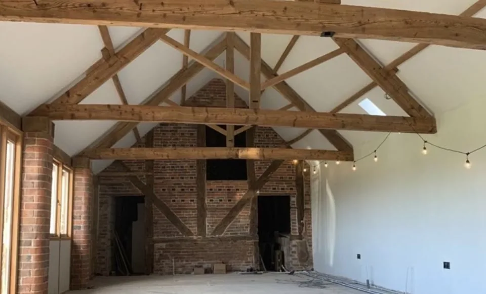 Refreshed oak A-frame structure with a cleaner brighter grain after gentle restoration