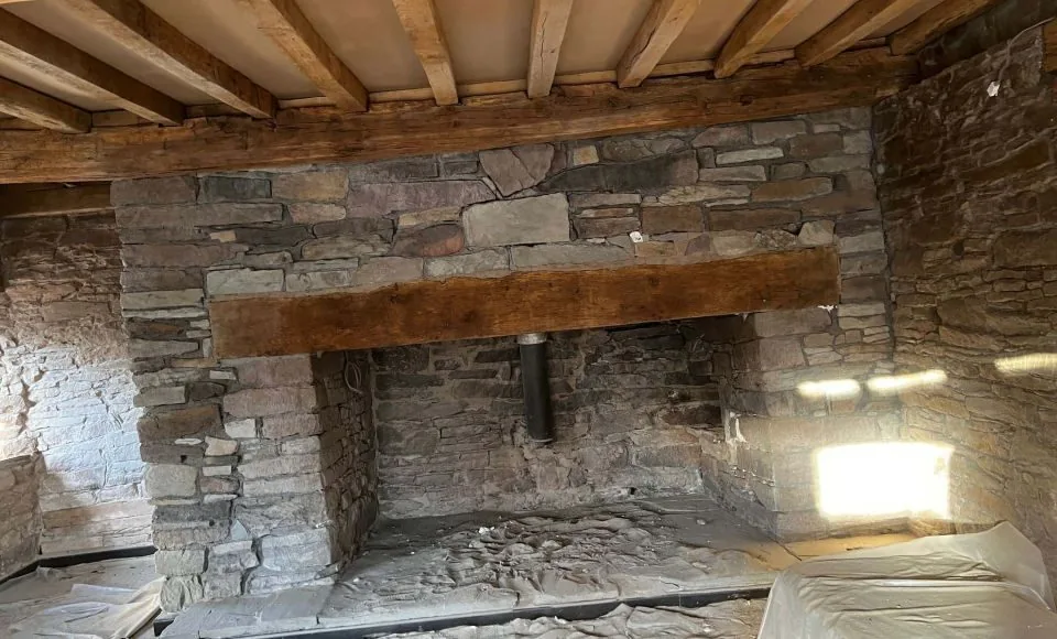 Refreshed brick and stone fireplace with cleaner detail and renewed focal-point character