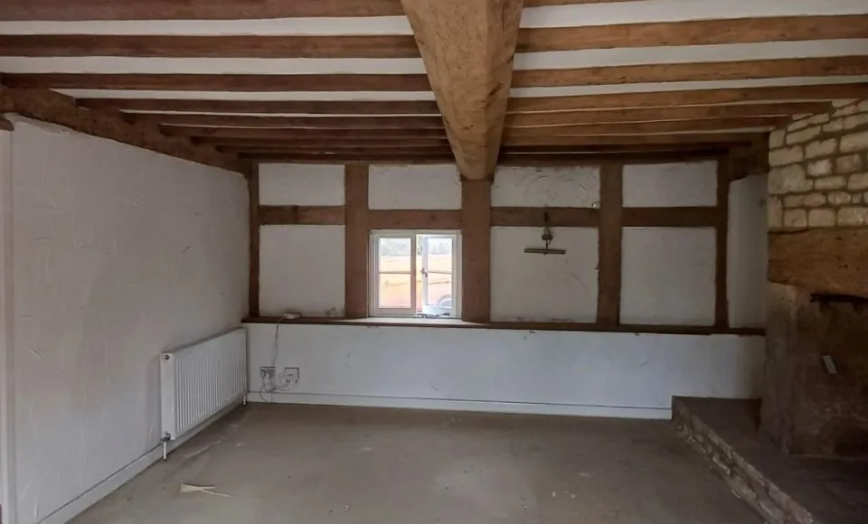 Clean warm oak framing and refreshed stone inglenook after careful restoration