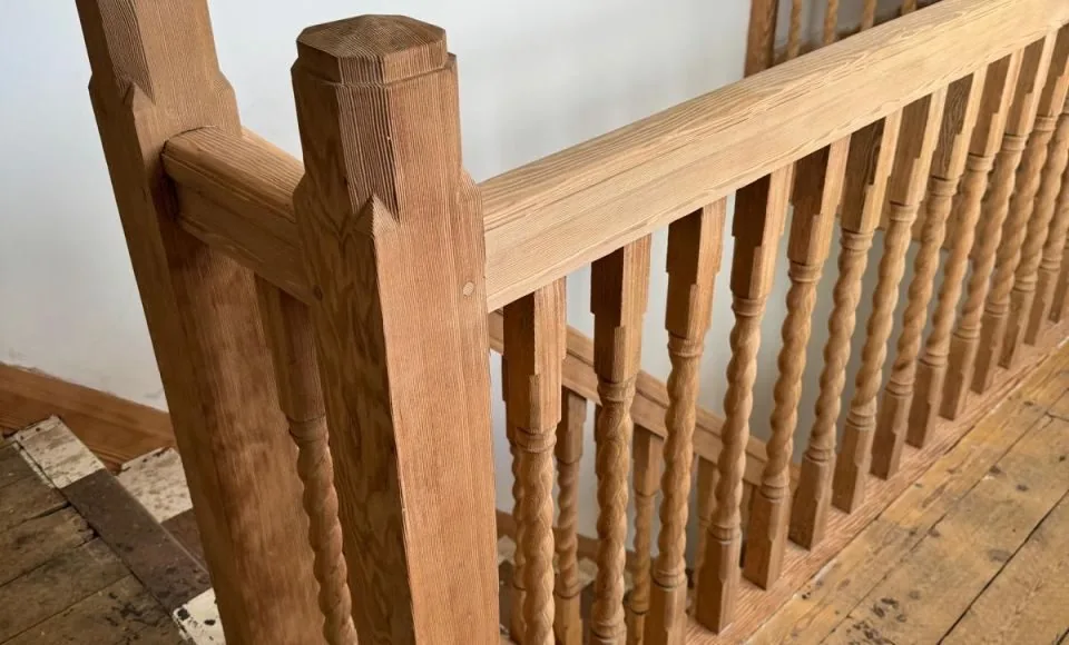 Cleaned Victorian staircase balustrade showing brighter timber and clearly defined barley-twist spindles