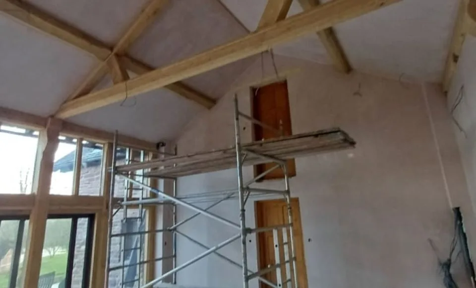 Restored vaulted oak beams and trusses showing clean grain and warmer timber tones