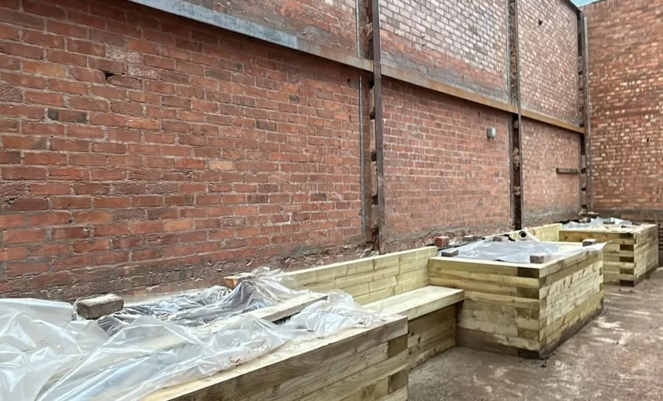 Restored listed building elevation with cleaner brickwork and revealed stone details