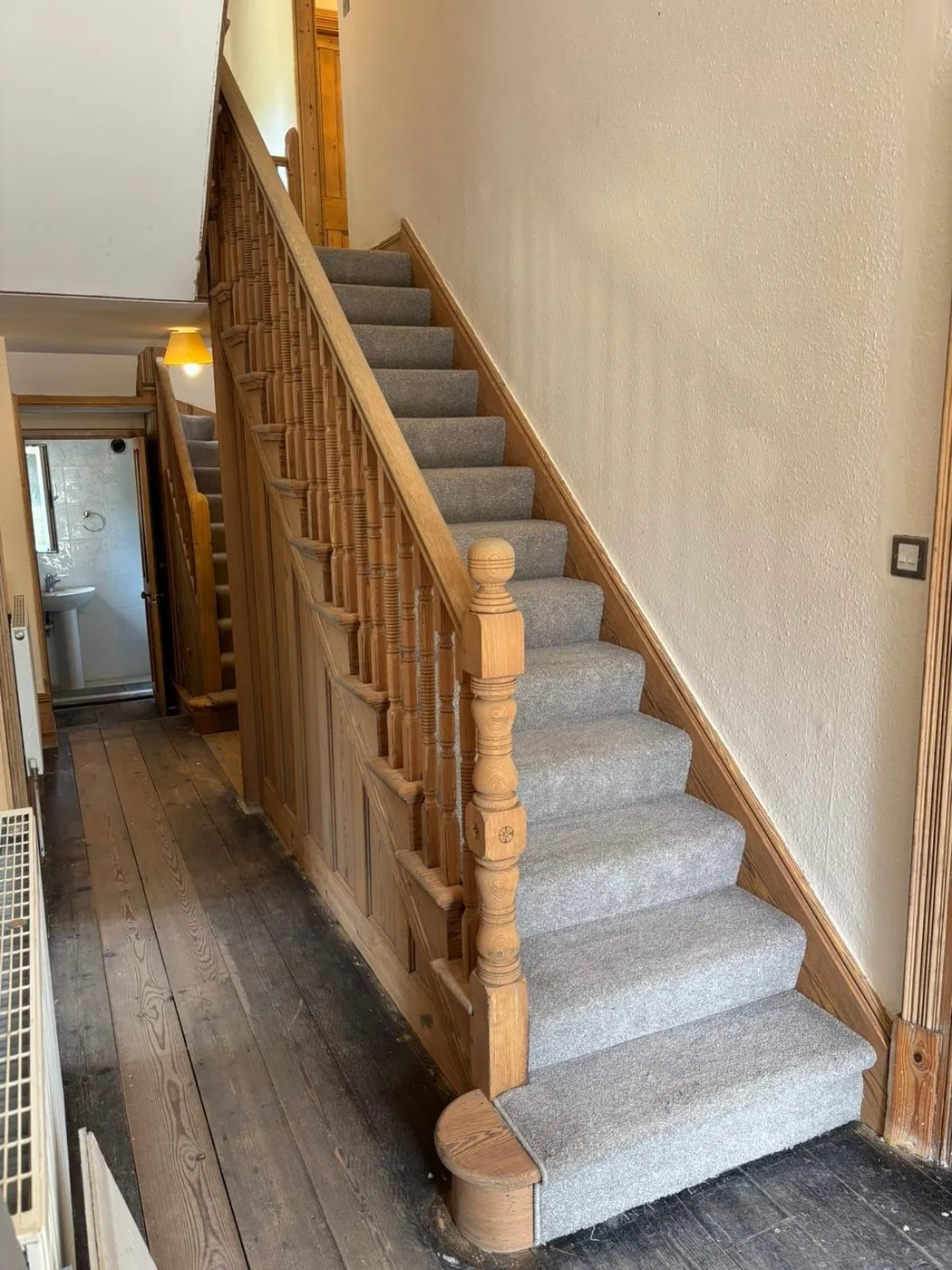 Cleanly restored Victorian staircase showing brighter timber, defined balusters and preserved period detail