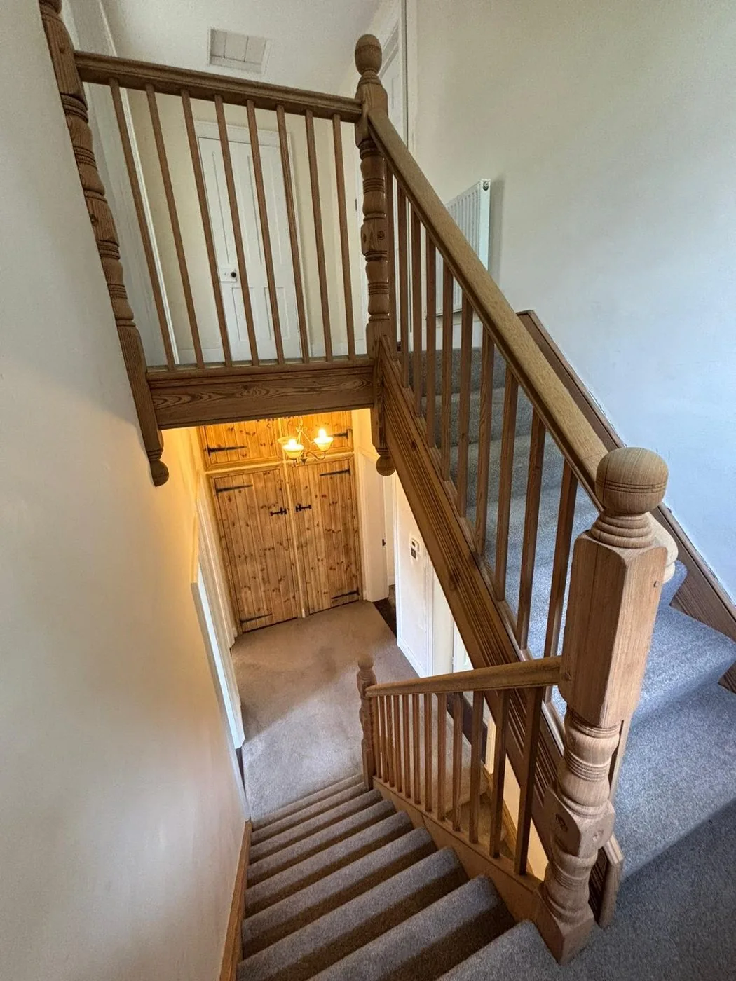 Restored staircase landing with even clean woodwork and sharply defined decorative panelling