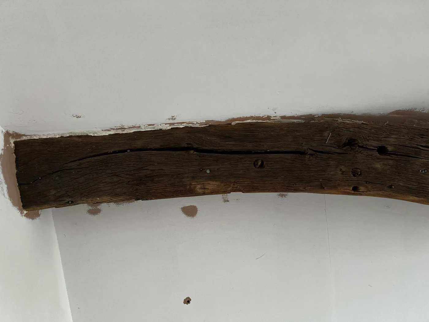 Historic oak beam structure after restoration with an even clean surface ready for finishing