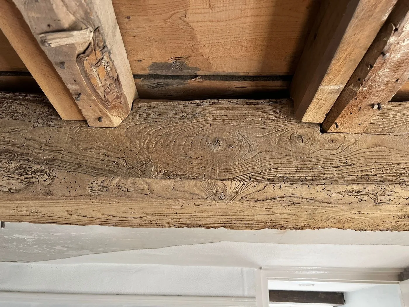 Clean restored oak ceiling beams with natural grain and historic character visible