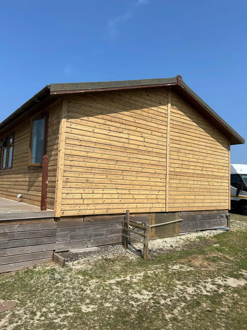 Clean horizontal log walls after gentle restoration with an even, refreshed natural timber finish
