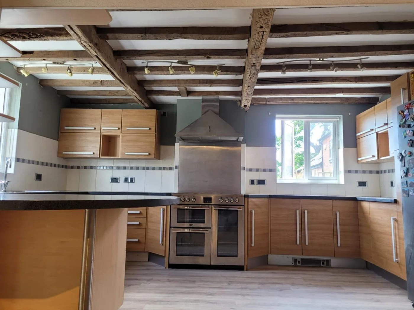 Cleaned period oak ceiling beams showing lighter grain after restoration