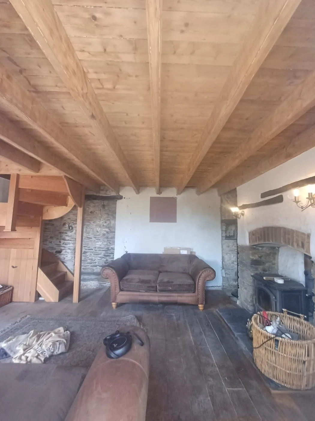 Clean warm-toned oak ceiling beams restored above the traditional cottage interior