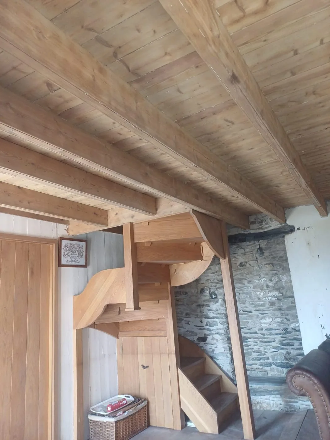 Naturally finished oak beams revealed beside the cottage stone walls and inglenook fireplace
