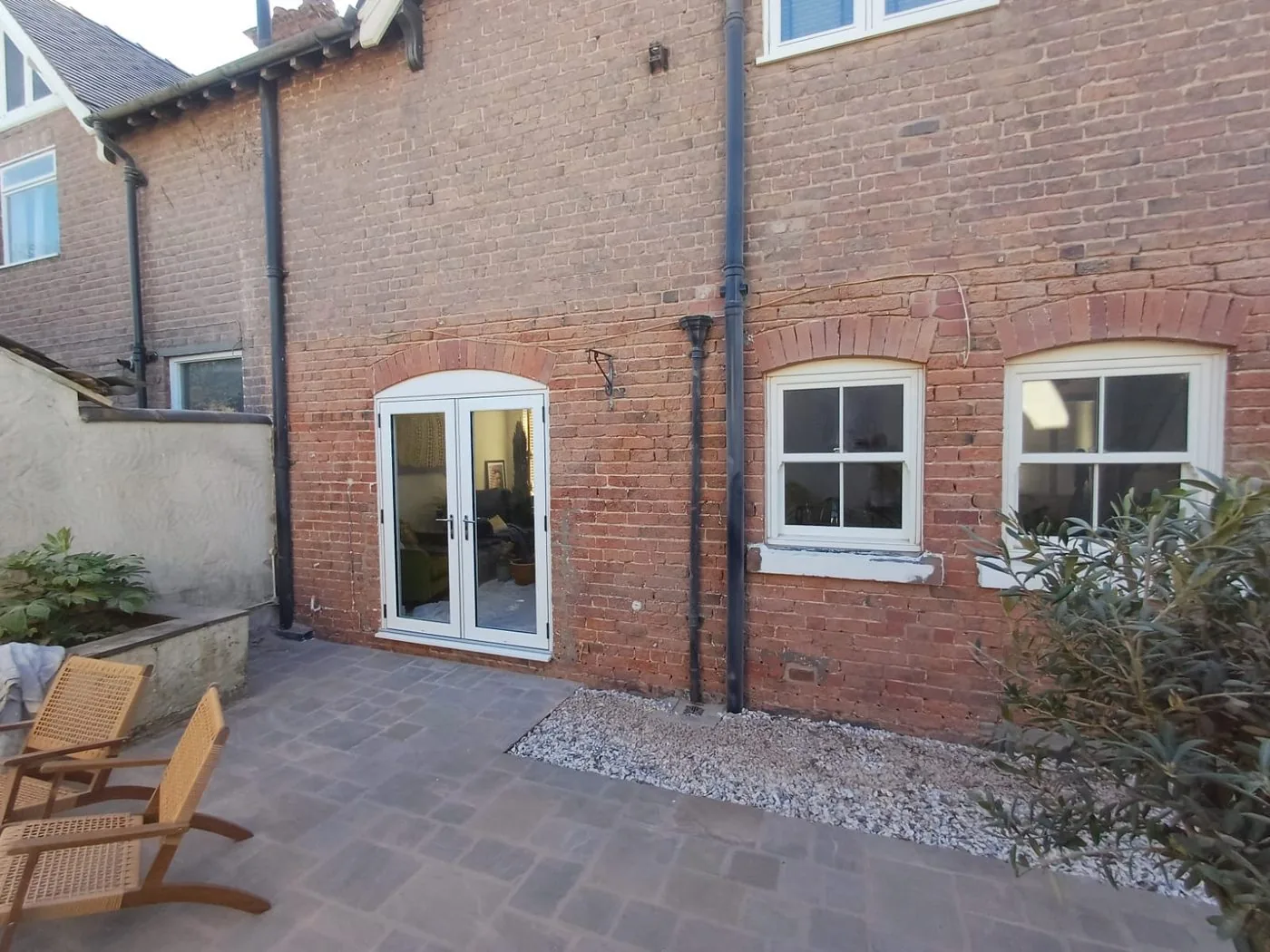 Restored red Victorian courtyard brickwork exposed with crisp arches and period detail visible
