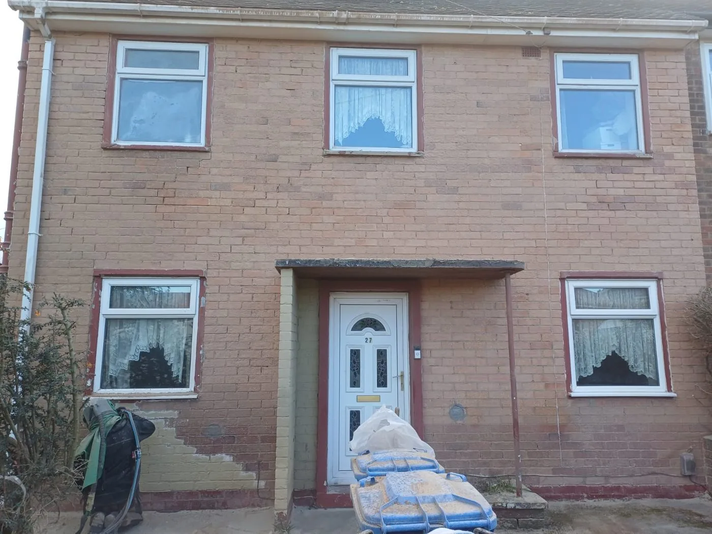 Detached house exterior showing clean natural brickwork after controlled paint removal