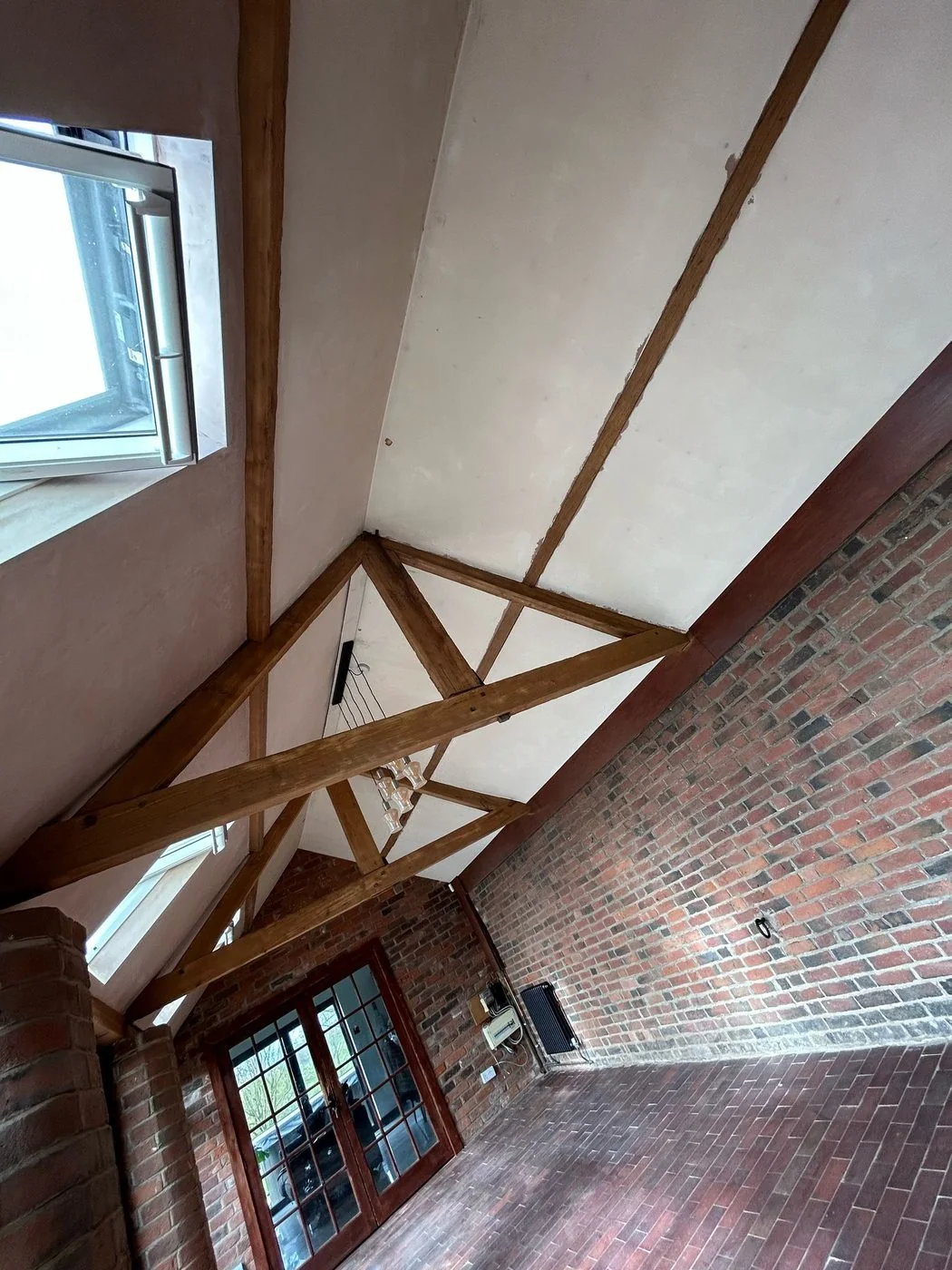 Additional restored view of a vaulted ceiling with exposed timber trusses