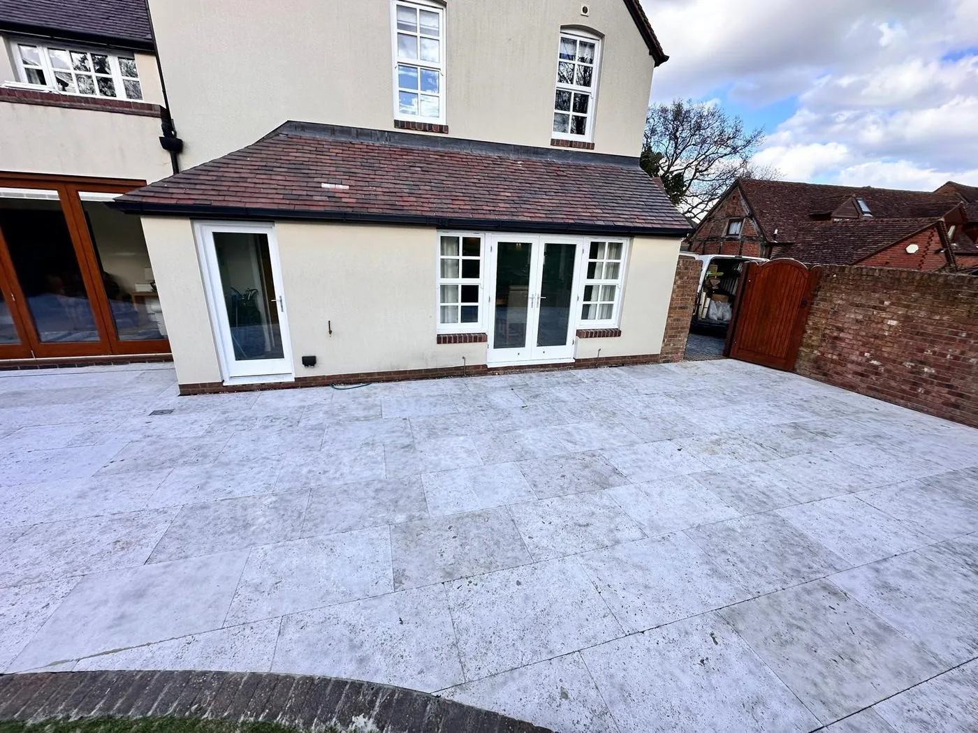 Cleaned limestone entertaining area showing an even, refreshed surface and clearer paving definition.