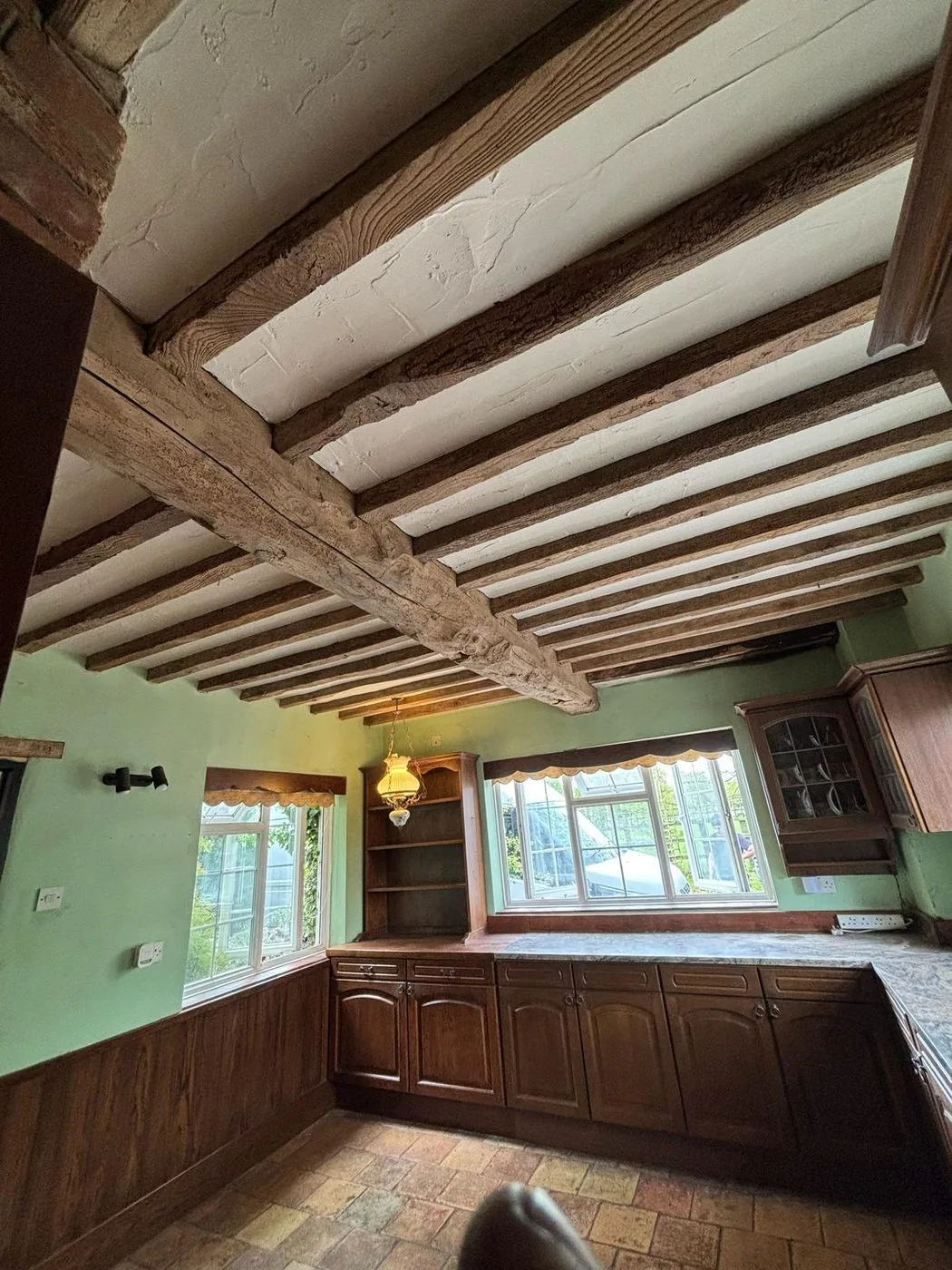 Restored oak ceiling beams with a cleaner warm natural finish