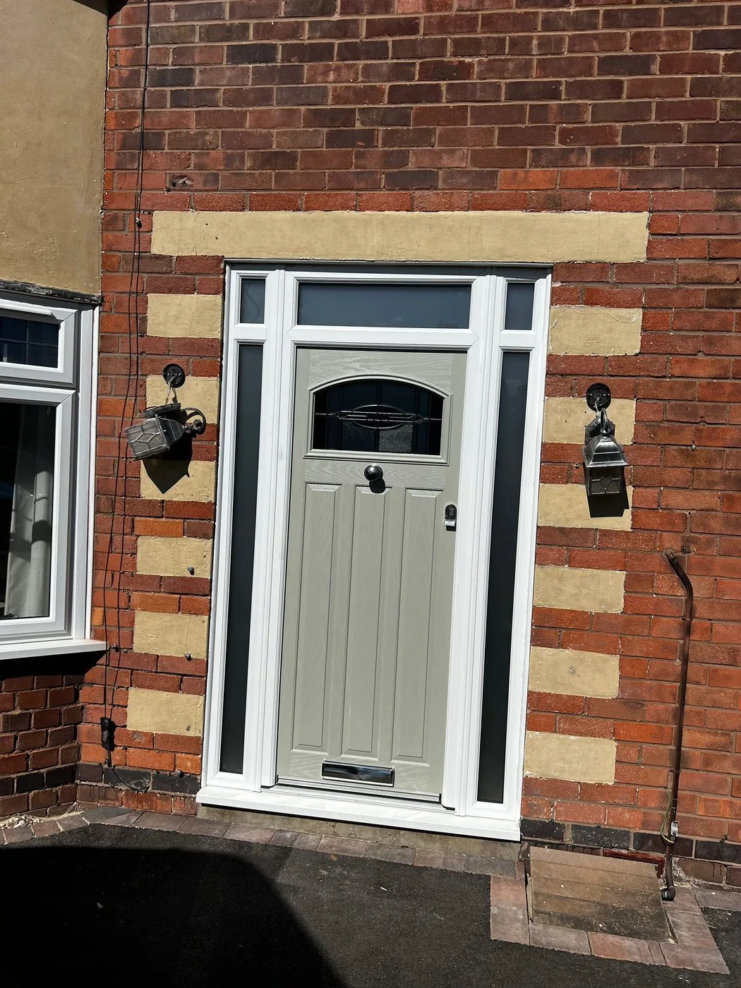 Clean front doorway showing restored brick and stone banding