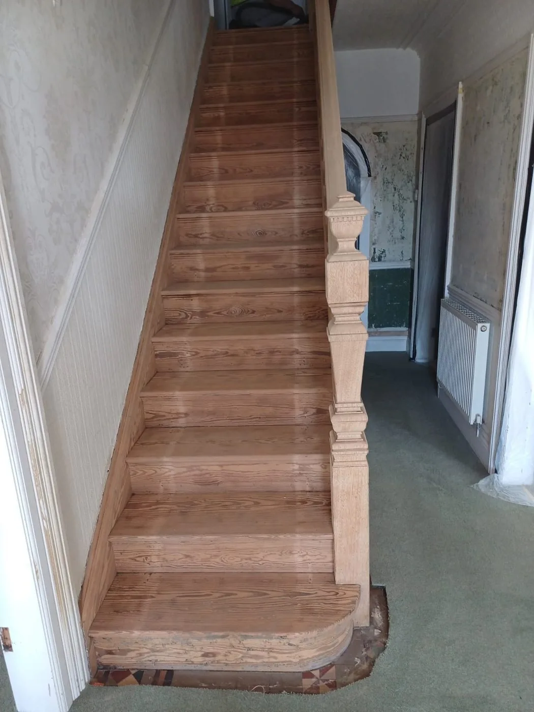 Restored Victorian staircase showing lighter timber, defined balusters and clean decorative panelling