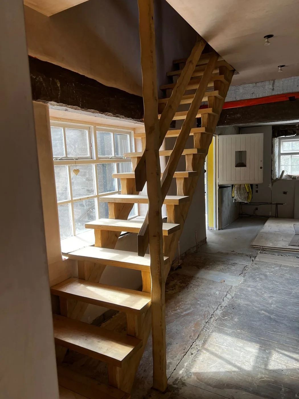 Clean finished view of ornate timber stair joinery after controlled surface preparation