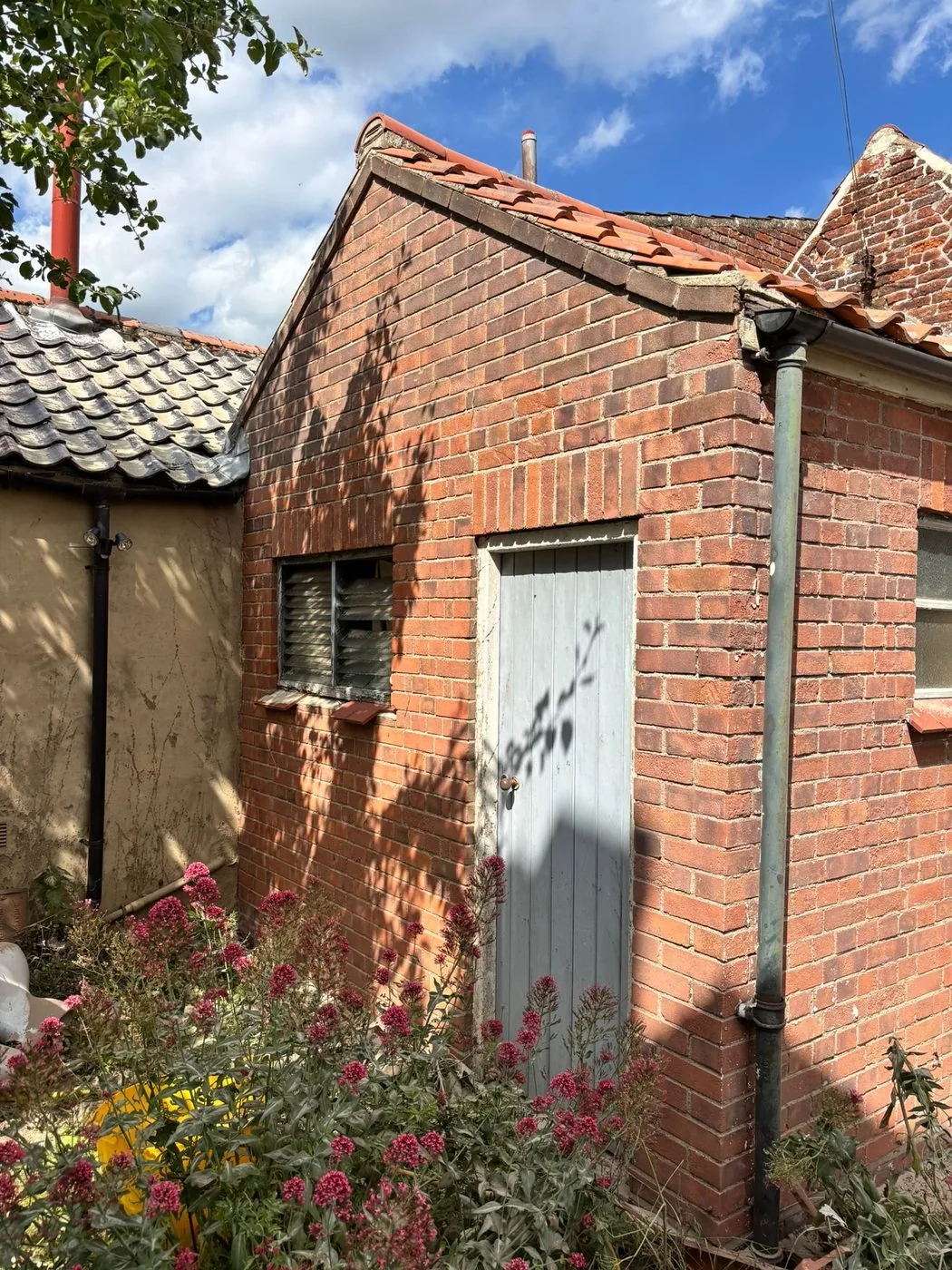 Clean exposed brickwork across the restored outbuilding showing an even natural finish