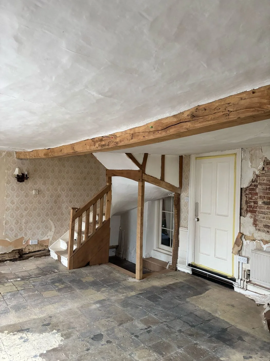 Restored oak staircase and balustrade showing clearer grain and an even heritage-ready surface