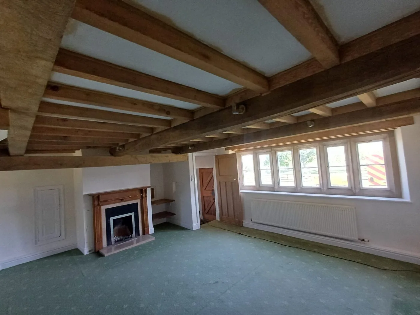 Freshly restored oak ceiling beams with warm natural grain in a period room